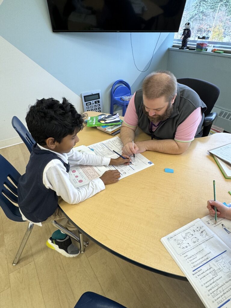 teacher giving individualized support for student with learning challenges